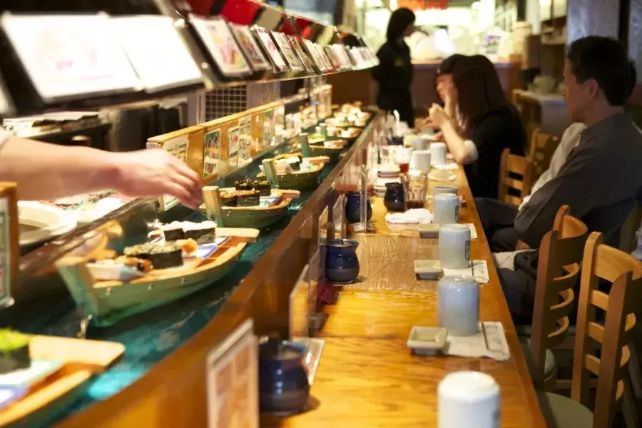 Image of sushi going by on mini-boats